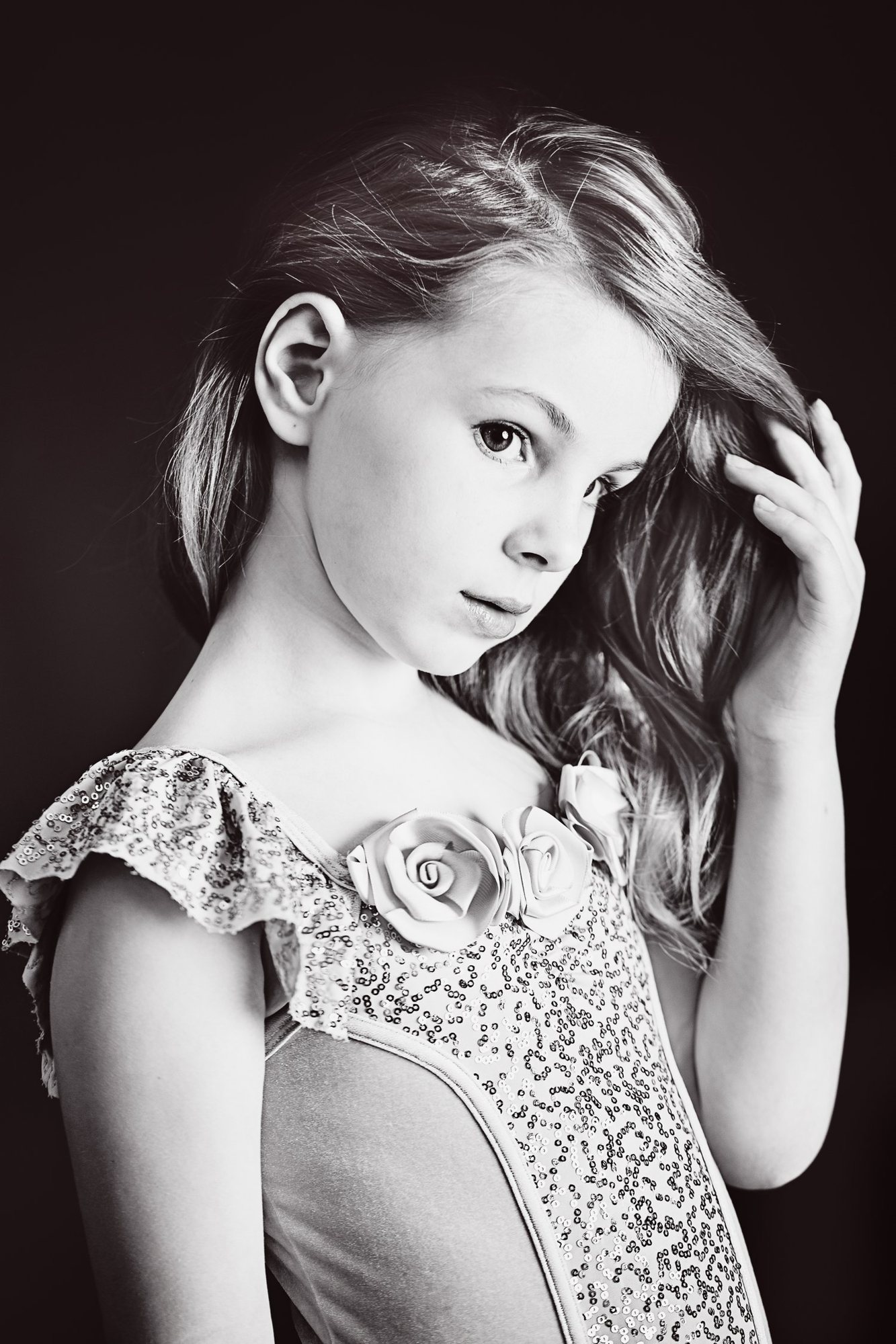 Black and white close portrait of a girl in an embellished dress