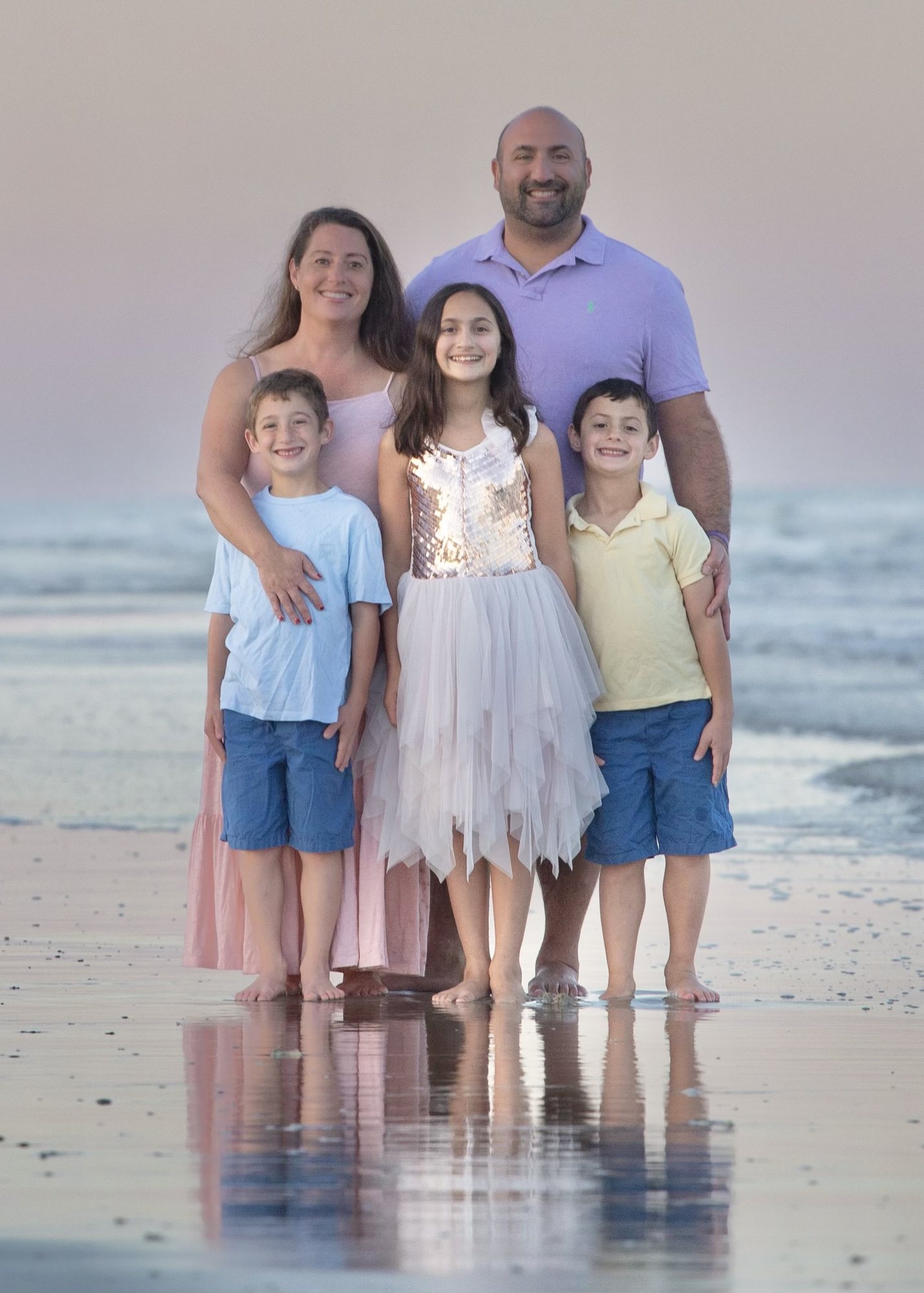 Family portrait on the beach at sunset